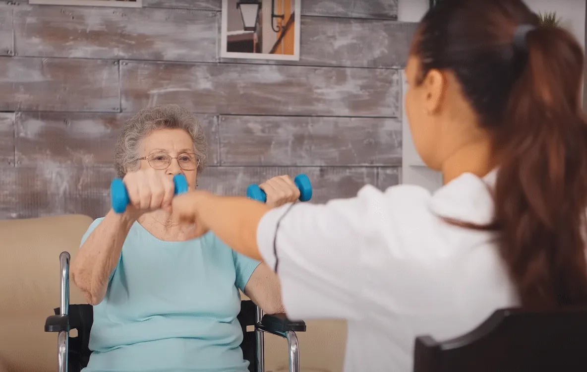 Physical therapist helping patient with frozen shoulder exercises and stretching